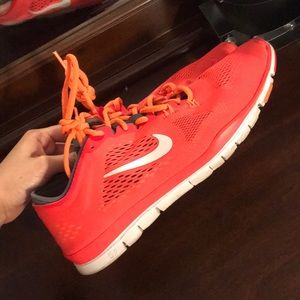 Coral/orange/red/white running Nike shoes